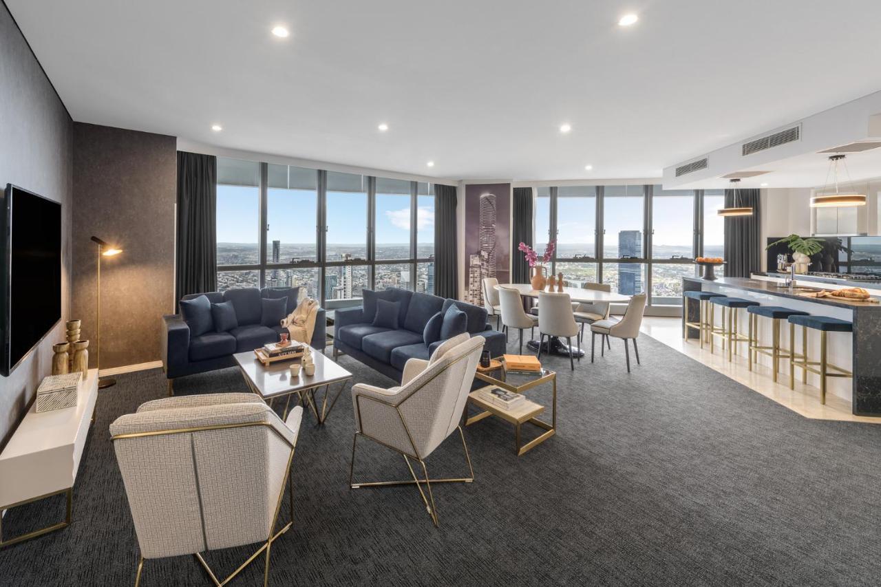 赫歇尔街美利通套房酒店 布里斯班 外观 照片 The photo shows a modern and stylish interior of a living space, likely an apartment or a hotel suite. The room features large windows that allow plenty of natural light and offer a view of the city. 

In the foreground, there is a comfortable seatin